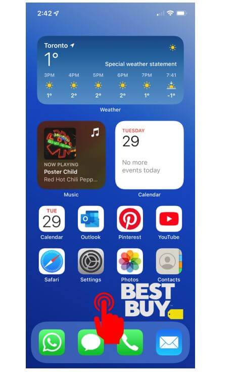 iPhone home screen with hand showing how to press and hold to edit home screen