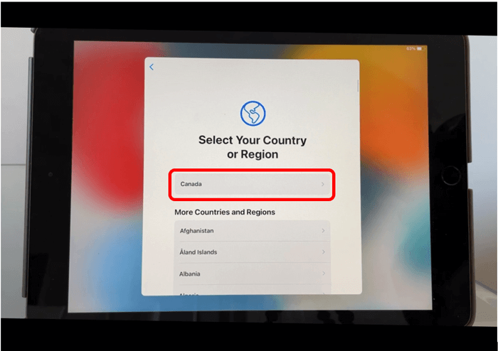 iPad screen with Select your Country or Region menu and Canada circled in red