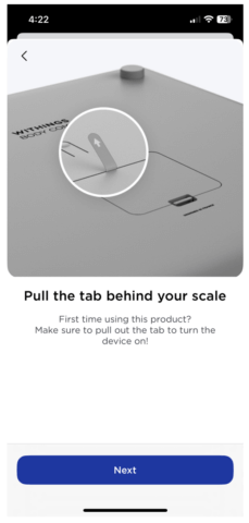 Back of Withings scale with tab highlighted to show how to pull the tab to turn the device on if this is the first time using the scale.