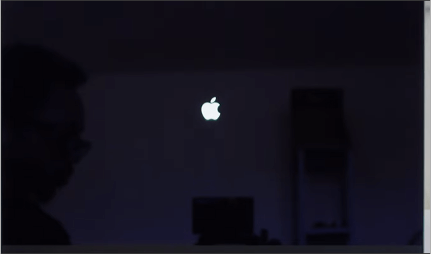 Black screen with white Apple logo in the center.